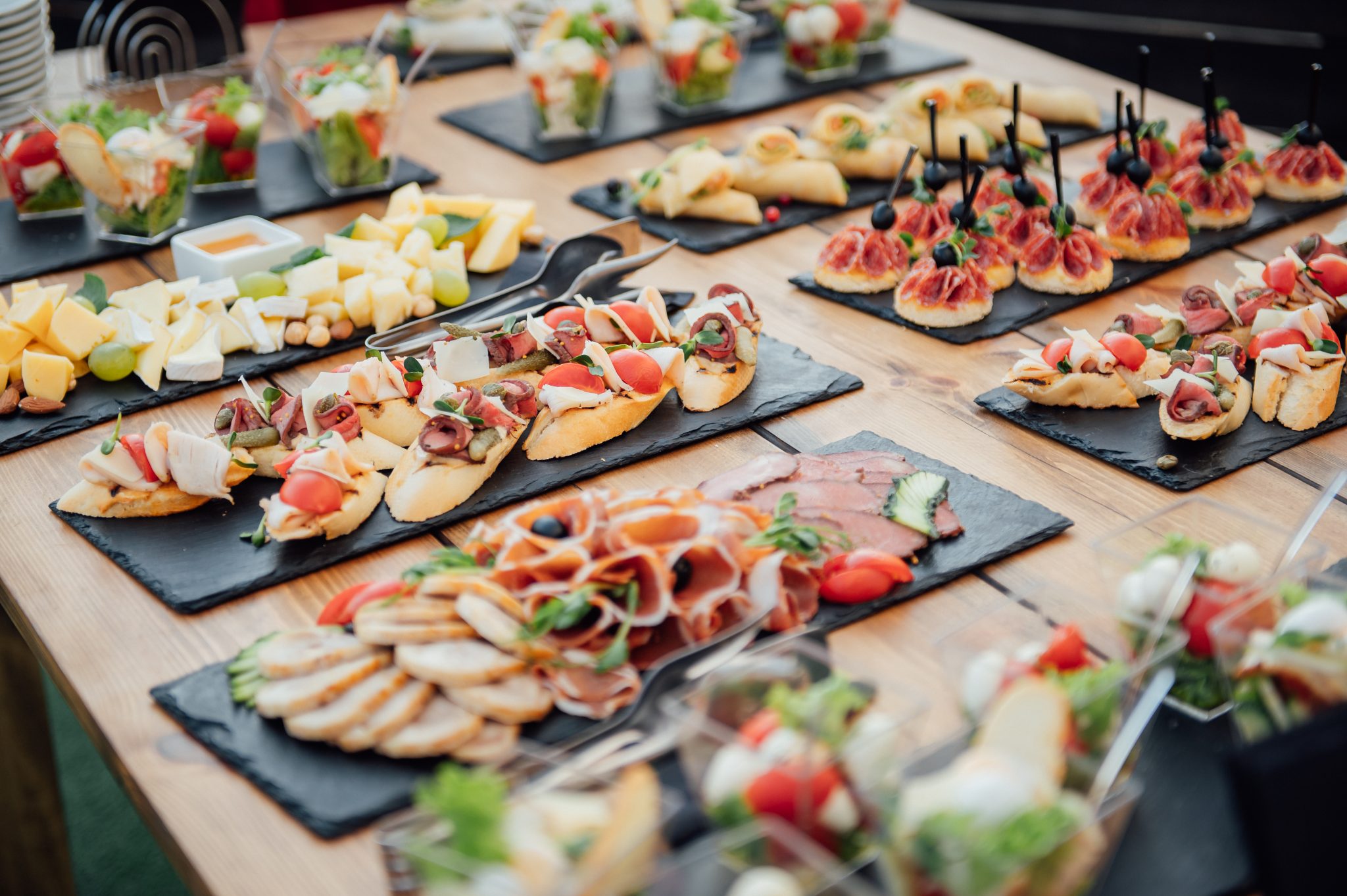 Buffet table of reception with burgers, cold snacks, meat and salads